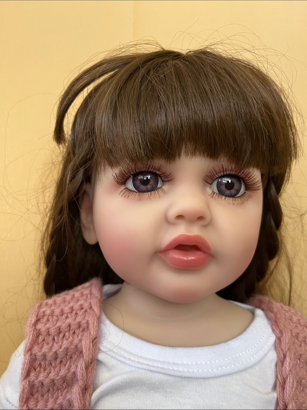 Reborn Brown-Haired Doll with Pink Knit Vest and White Top